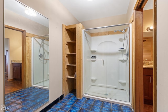bathroom featuring a stall shower and vanity