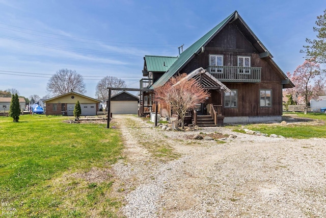 view of front of property with dirt driveway, an outdoor structure, a front lawn, and metal roof