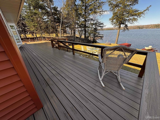 wooden terrace featuring a water view