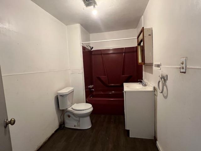 4110 N Clare Ave, Harrison, MI 48625 - full bathroom with vanity, shower / bathing tub combination, wood finished floors, and toilet