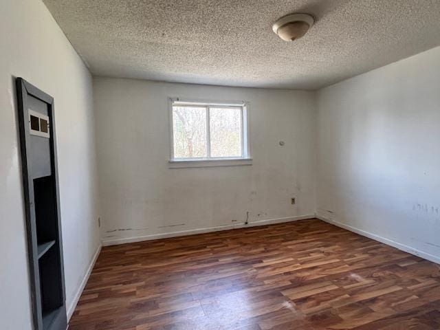 4110 N Clare Ave, Harrison, MI 48625 - unfurnished room featuring a textured ceiling, baseboards, and wood finished floors