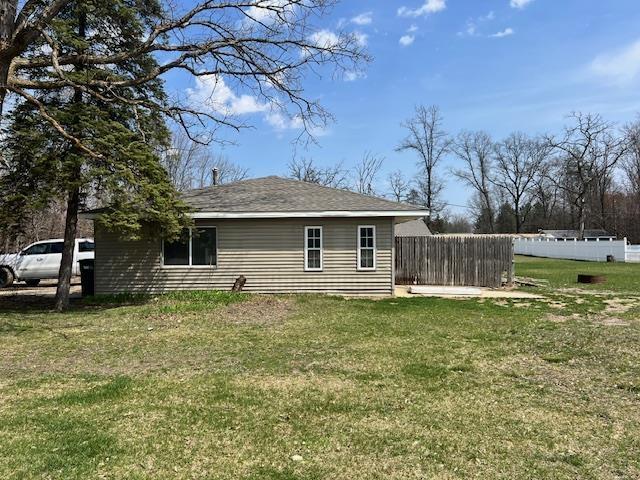 4110 N Clare Ave, Harrison, MI 48625 - view of side of home featuring fence and a yard