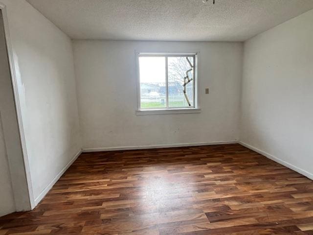 4110 N Clare Ave, Harrison, MI 48625 - unfurnished room with a textured ceiling, baseboards, and wood finished floors