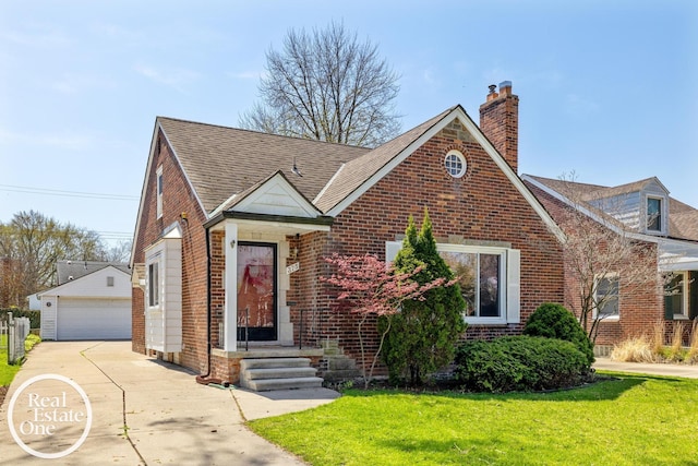 view of front facade with a detached garage, brick siding, a front lawn, and a chimney