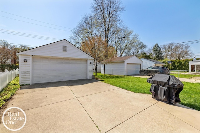 detached garage featuring fence