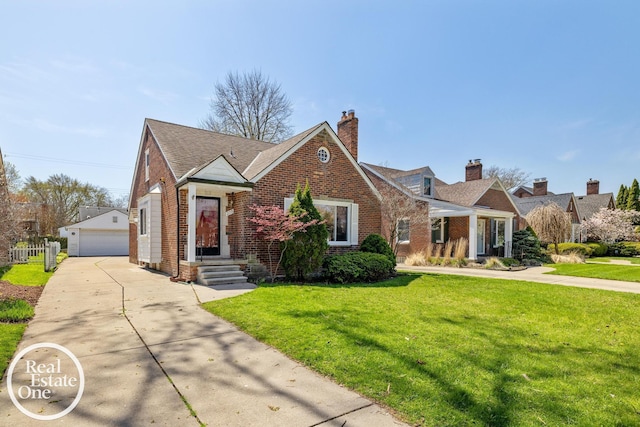 view of front of house with a garage, brick siding, an outdoor structure, and a front lawn