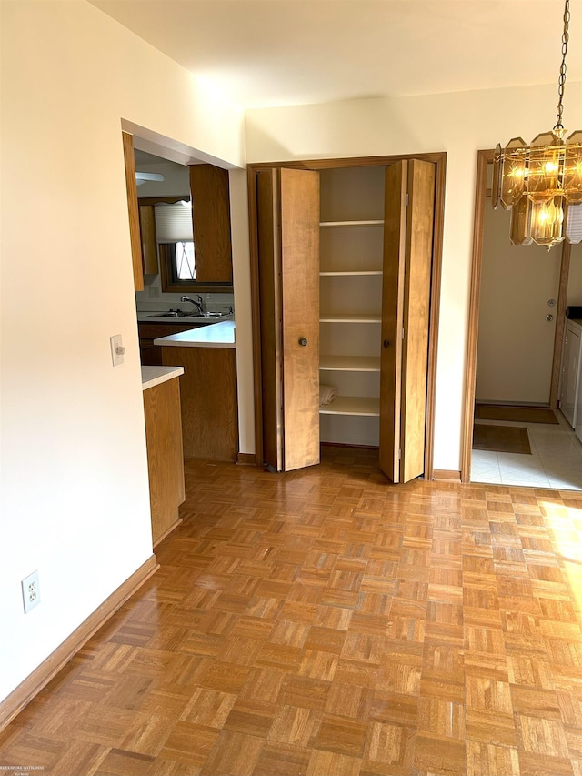 interior space with baseboards and a notable chandelier