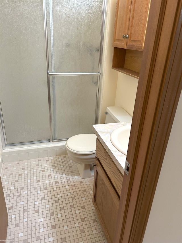 full bathroom with vanity, tile patterned flooring, toilet, and a shower stall