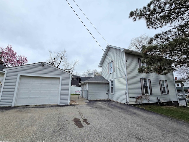 303 N 5th St, Saint Clair, MI 48079 - view of home's exterior with an outdoor structure, a detached garage, and aphalt driveway