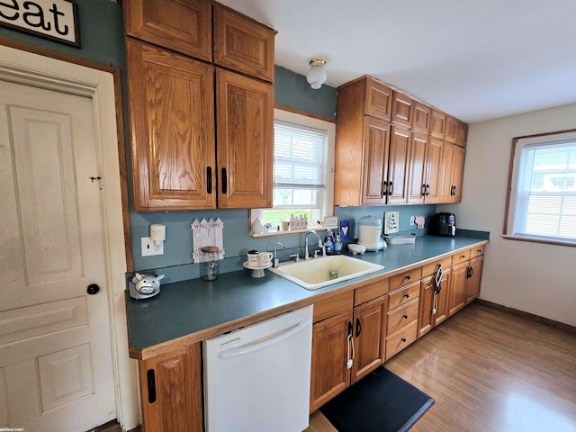303 N 5th St, Saint Clair, MI 48079 - kitchen with light wood-style floors, brown cabinets, white dishwasher, and a sink