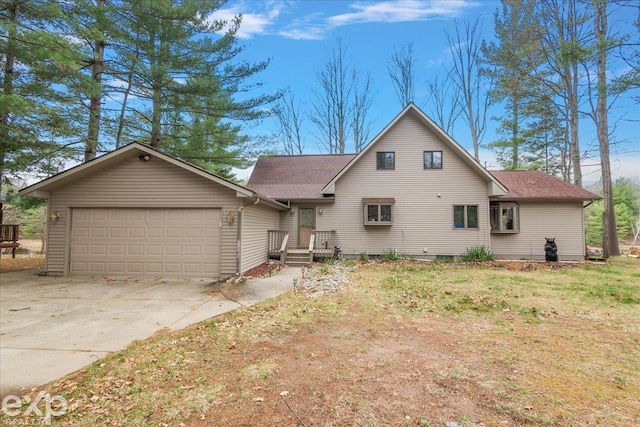 view of front of home featuring driveway, a shingled roof, and an attached garage