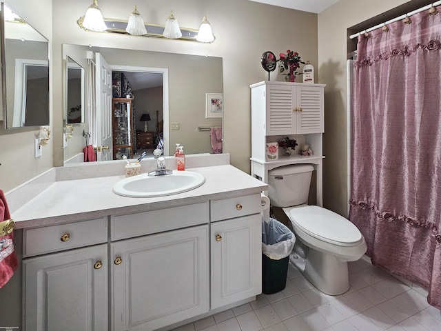 bathroom featuring tile patterned floors, toilet, vanity, and ensuite bathroom