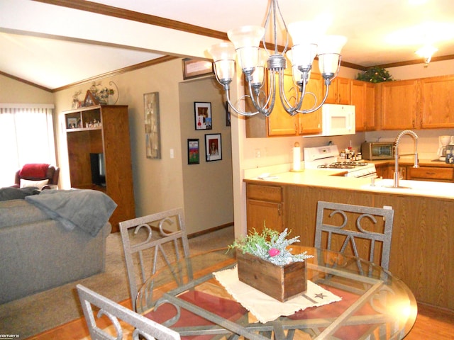 kitchen with a chandelier, white appliances, light countertops, and ornamental molding