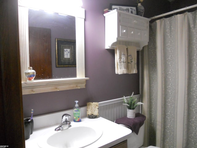 bathroom with curtained shower and vanity