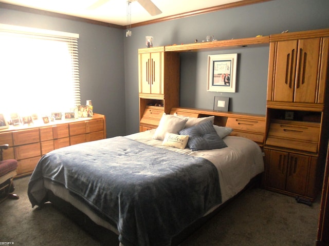 bedroom featuring ceiling fan, crown molding, and carpet flooring