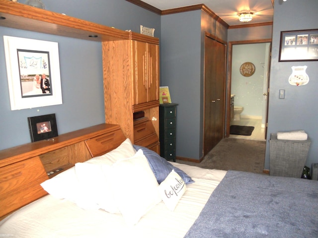 bedroom with ornamental molding and carpet floors
