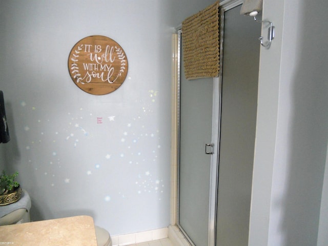 full bathroom featuring toilet and a shower stall