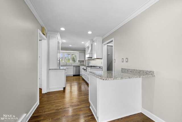 kitchen with dark wood finished floors, white cabinets, a peninsula, and crown molding