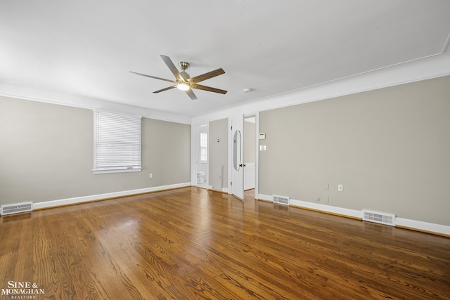 unfurnished room with baseboards, visible vents, and a ceiling fan