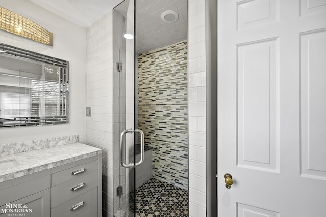 bathroom featuring a stall shower and vanity