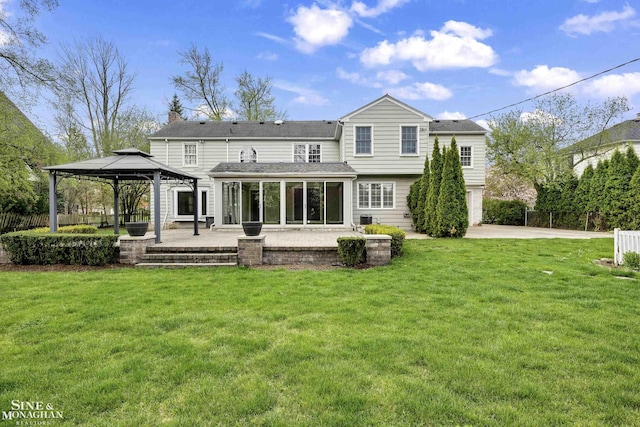 back of house featuring fence, a gazebo, a yard, and a patio