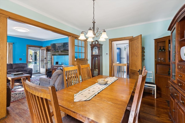 dining room featuring ornamental molding, dark wood-style floors, and a chandelier