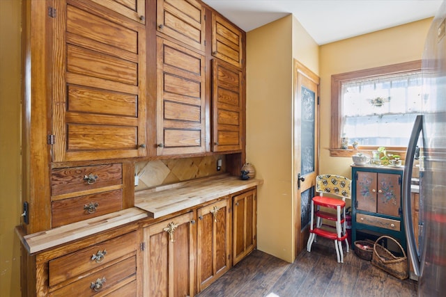kitchen featuring wooden counters, brown cabinetry, and dark wood finished floors
