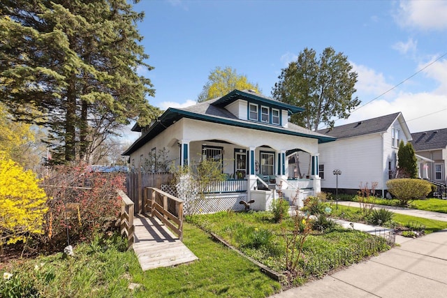 bungalow-style house with a porch and a front yard