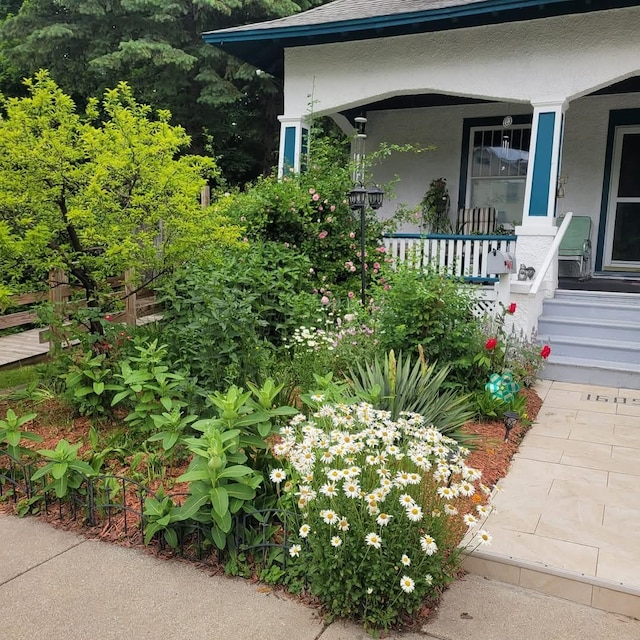 exterior space featuring covered porch and stucco siding