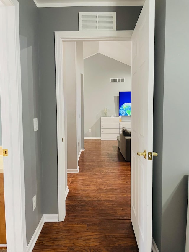 hallway with visible vents, wood finished floors, and baseboards