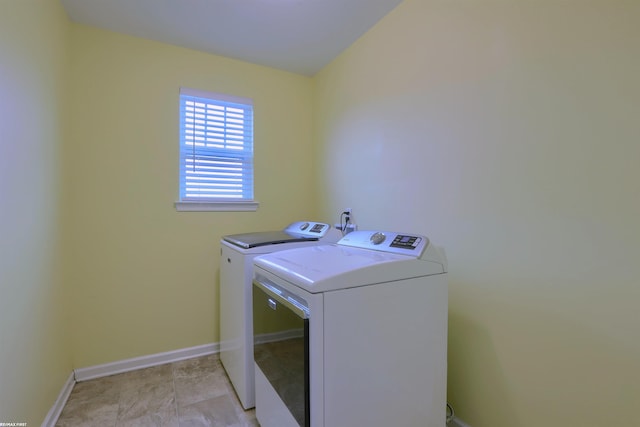 laundry area with washing machine and clothes dryer, laundry area, and baseboards