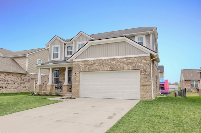 craftsman-style house with board and batten siding, stone siding, a front yard, concrete driveway, and an attached garage