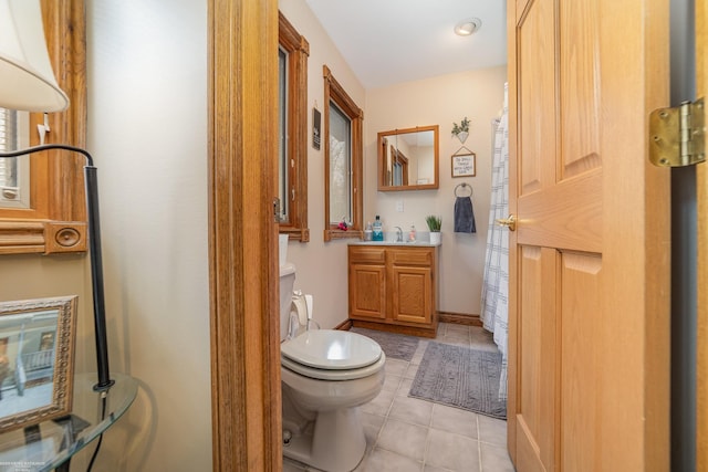 bathroom featuring vanity, toilet, and tile patterned flooring