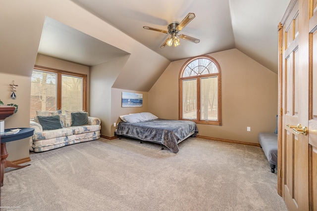 bedroom with a ceiling fan, carpet flooring, vaulted ceiling, and baseboards