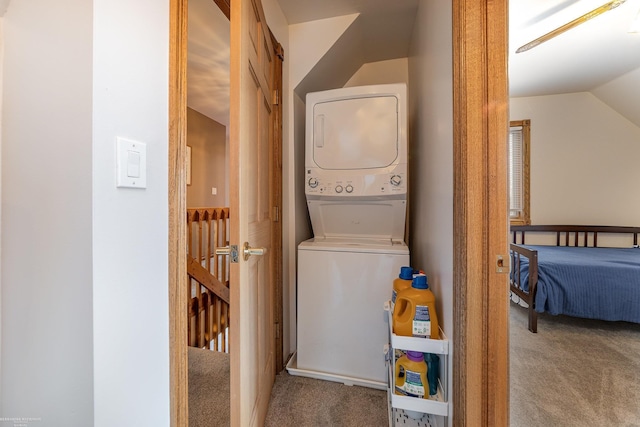 laundry room featuring stacked washer and dryer and carpet flooring