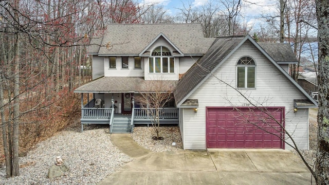 view of front of house featuring driveway, roof with shingles, covered porch, and a garage