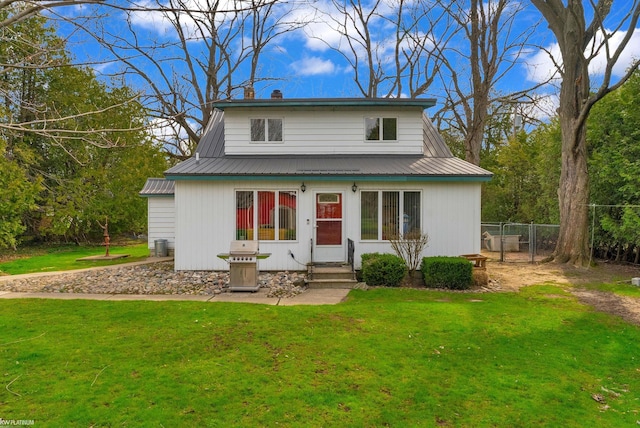 1121 S Lakeshore Rd, Carsonville, MI 48419 - view of front of house with metal roof, a front lawn, and entry steps