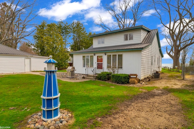 1121 S Lakeshore Rd, Carsonville, MI 48419 - rear view of house featuring metal roof, a yard, and central AC unit