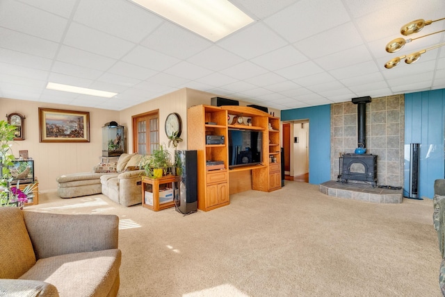 1121 S Lakeshore Rd, Carsonville, MI 48419 - carpeted living room with a paneled ceiling and a wood stove