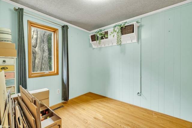 1121 S Lakeshore Rd, Carsonville, MI 48419 - spare room featuring visible vents, wood finished floors, a textured ceiling, and crown molding