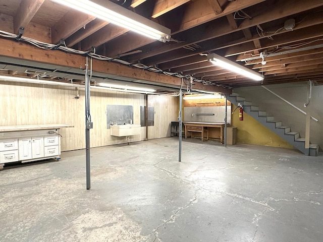 unfinished below grade area featuring stairway and a sink