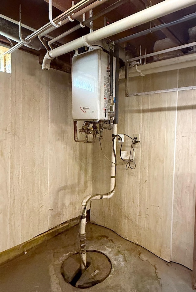 unfinished basement featuring water heater