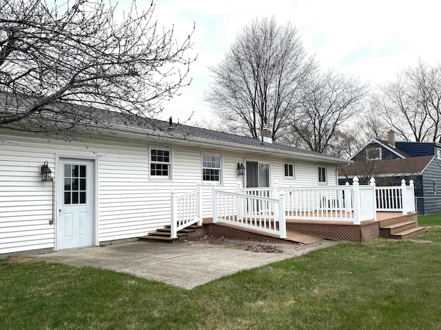rear view of house with a deck, a yard, and a patio