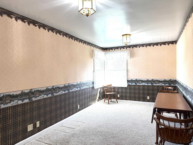living area featuring wallpapered walls, a wainscoted wall, and carpet floors