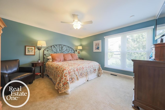 bedroom featuring carpet, ornamental molding, ceiling fan, baseboards, and visible vents
