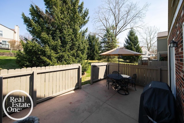 view of patio / terrace featuring fence, outdoor dining space, and grilling area