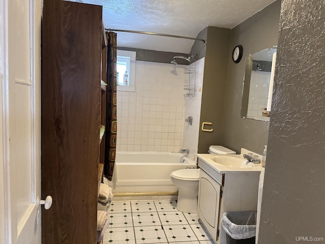 full bathroom with a textured ceiling, toilet, tile patterned floors, vanity, and bathtub / shower combination
