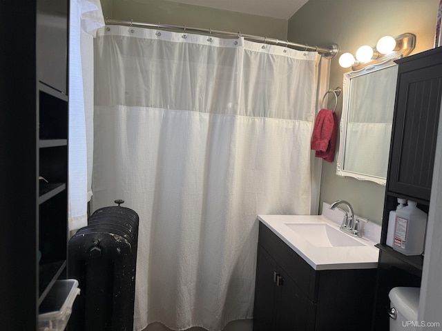 bathroom featuring toilet, curtained shower, and vanity