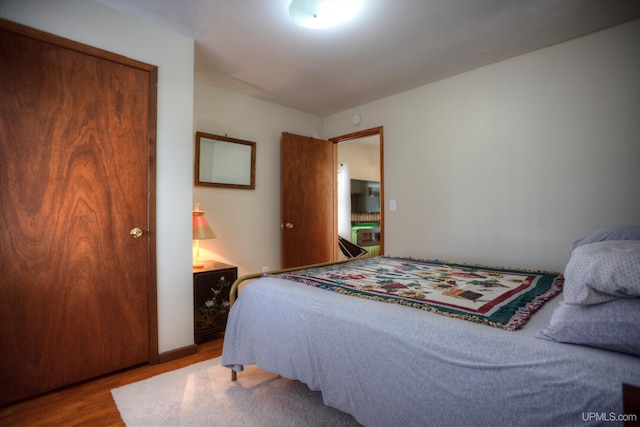 bedroom with wood finished floors
