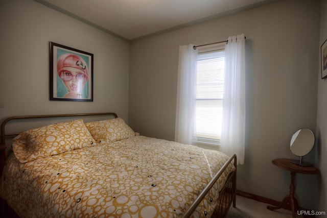 bedroom with baseboards and carpet